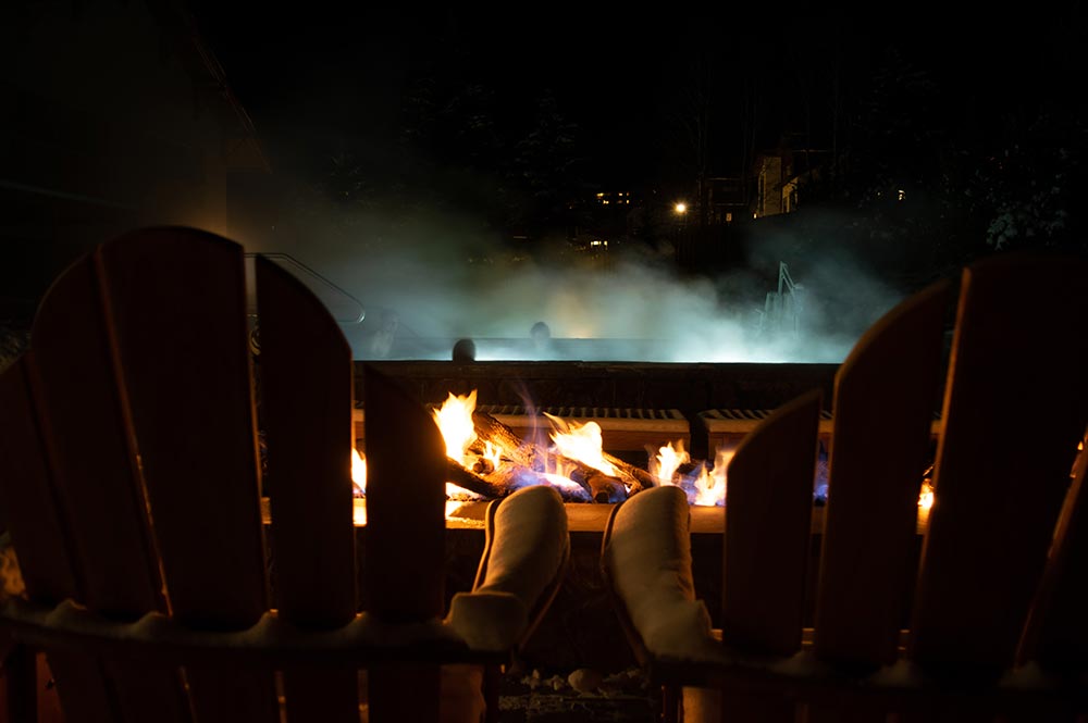 Highline Vail Hotel Firepit Chairs Looking at Hot Tub at Night in Winter