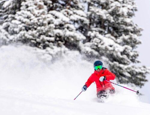 Vail Lifestyle Skier Skiing Down Slope in Red Coat